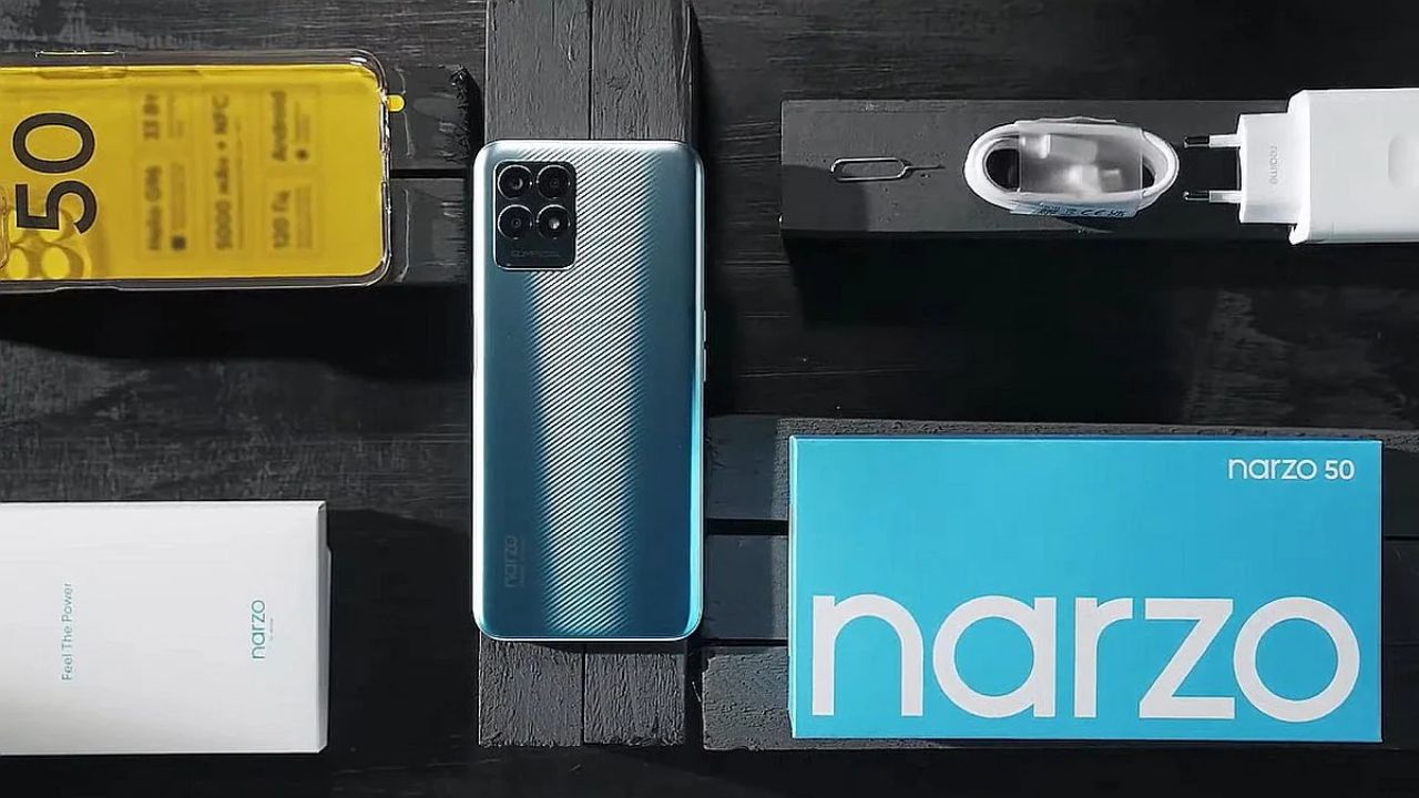 realme narzo 50 in light blue color with all accessories and box content on table