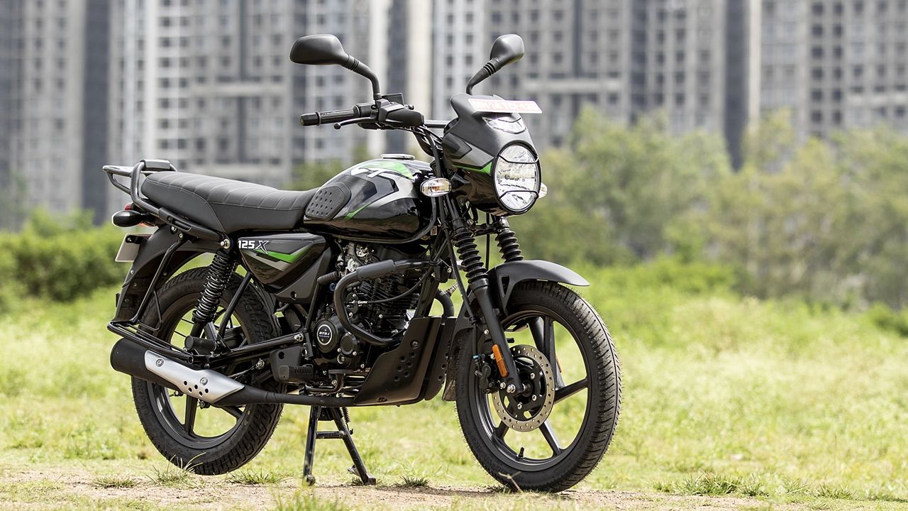 Bajaj CT 125 X in black color infront of some buildings and green plants