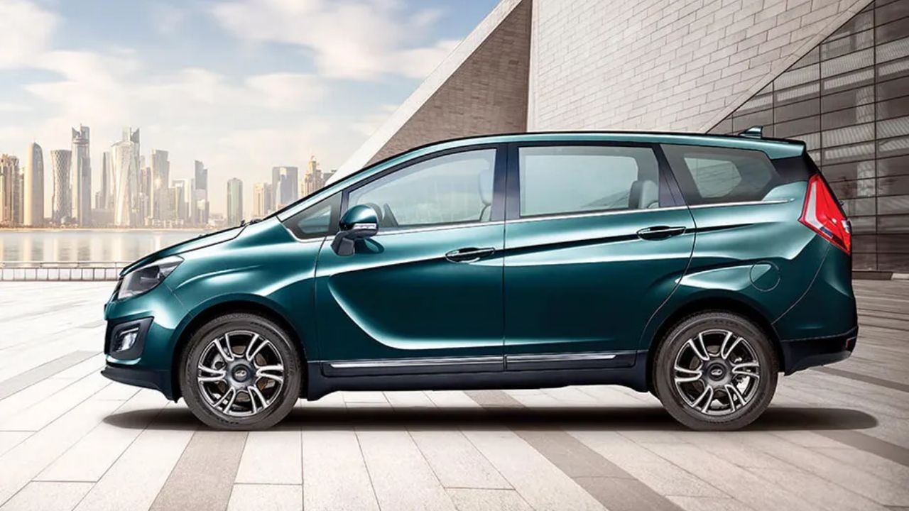 Mahindra Marazzo in dark green color near a building