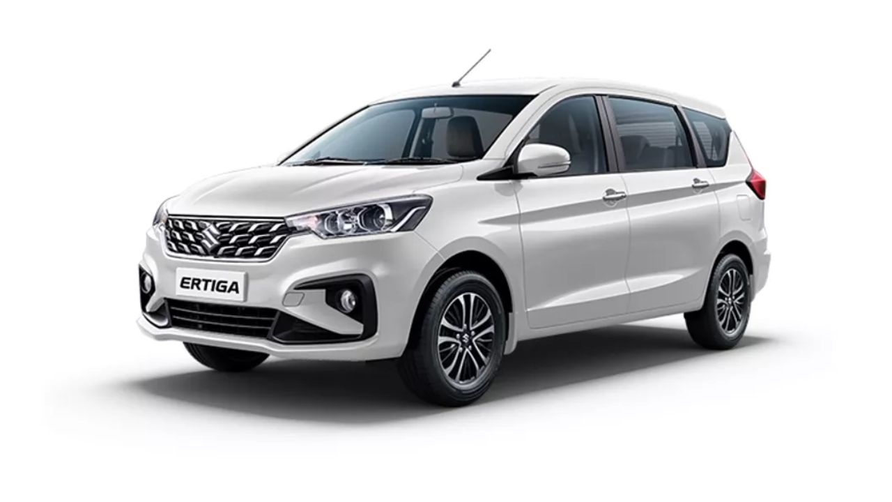 New Maruti Ertiga MPV in white color with black wheel infront of plain white background