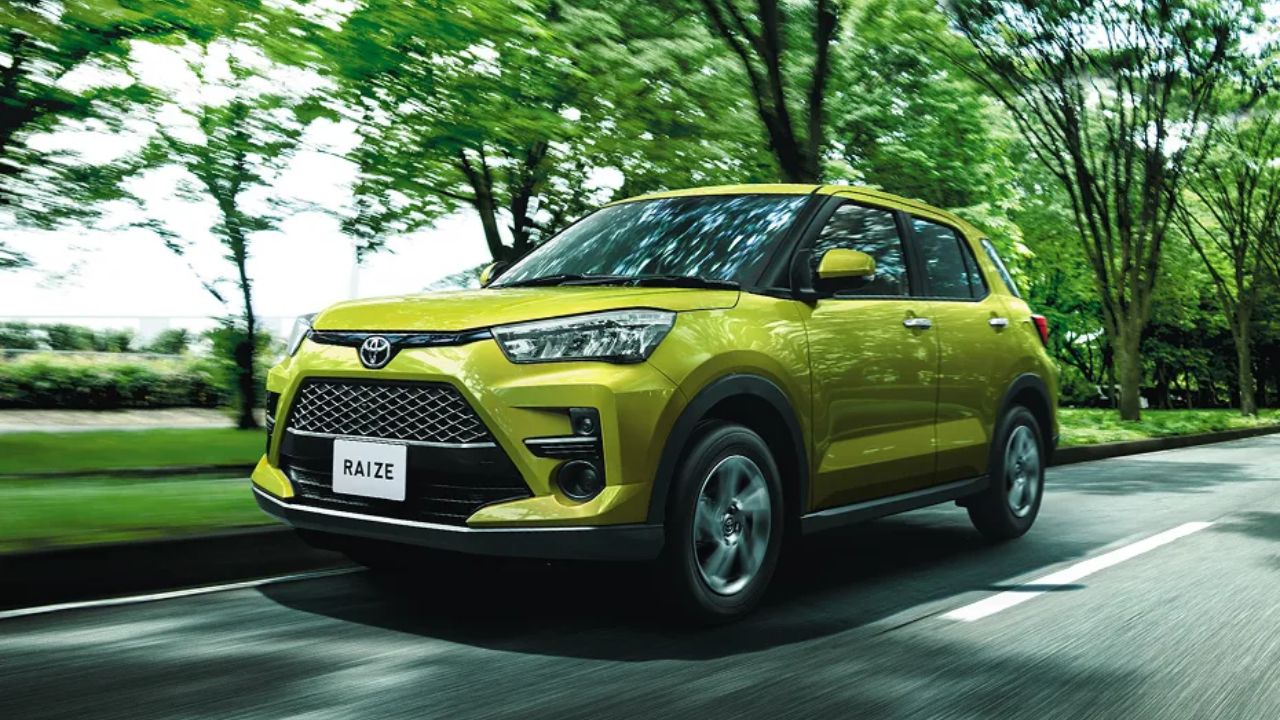 Toyota Raize SUV in green color on road infront of some trees