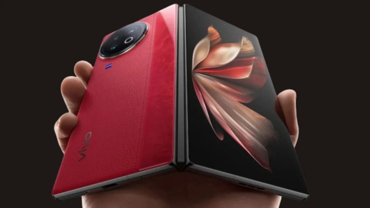 Vivo X Fold 3 Pro in velvet red color in hand infront od black color background