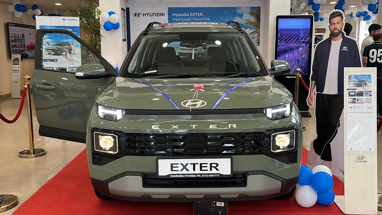 Hyundai Exter in olive color in showrrom on red mat