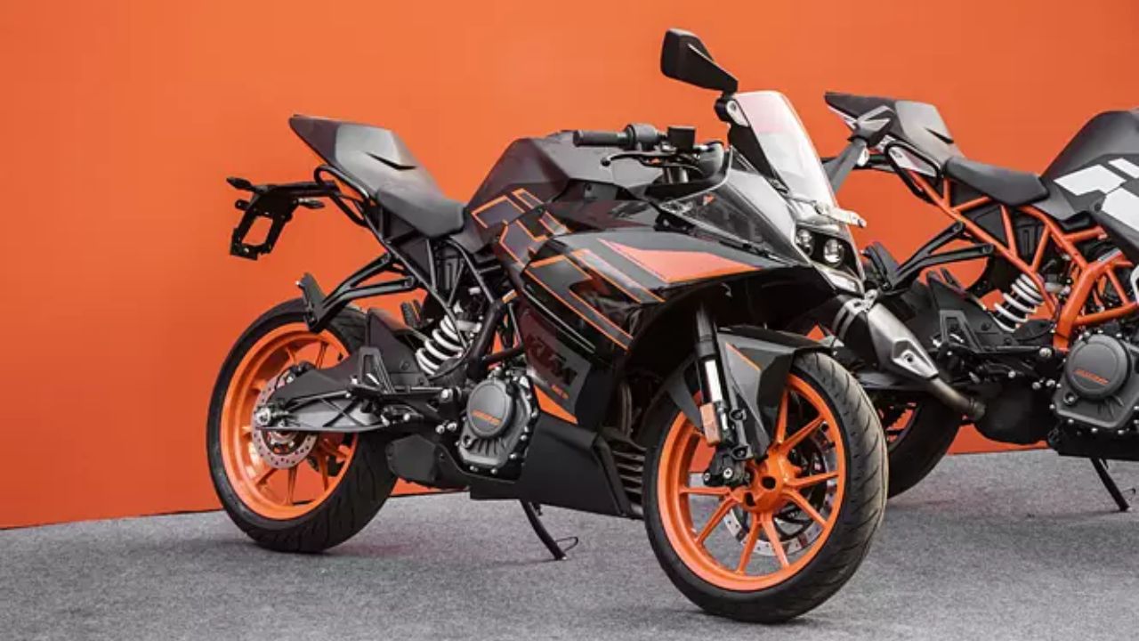 KTM RC 200 in orange and black color on road infront of orange color wall