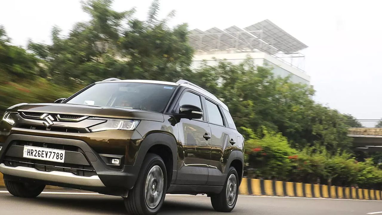 Maruti Suzuki Brezza CNG in grey color on road near some green plants