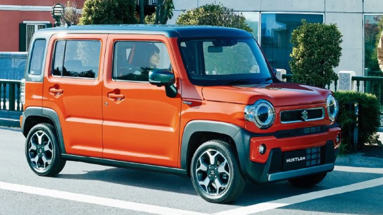 Maruti Suzuki Hustler in orange color on road near some trees