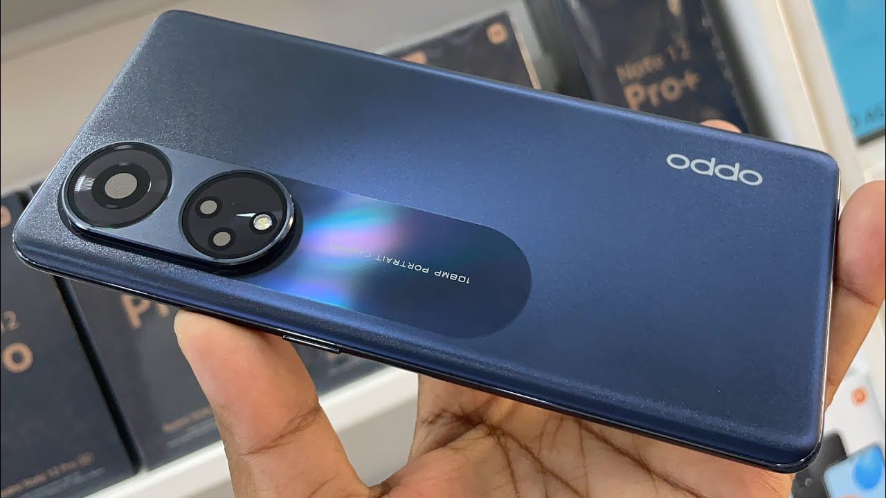 Oppo Reno 8T 5G in navy blue color in hand in a mobile phone shop