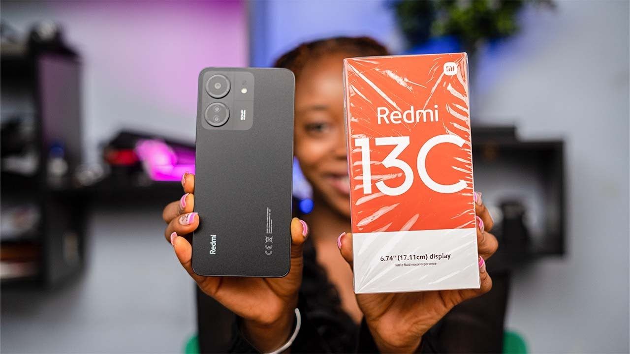 a women holding Redmi 13C in black color with box in a studio