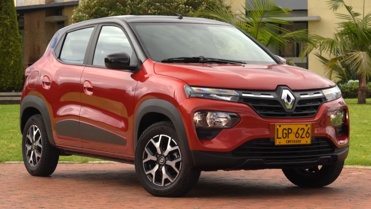 Renault Kwid in red color infront of bunglow near green plants