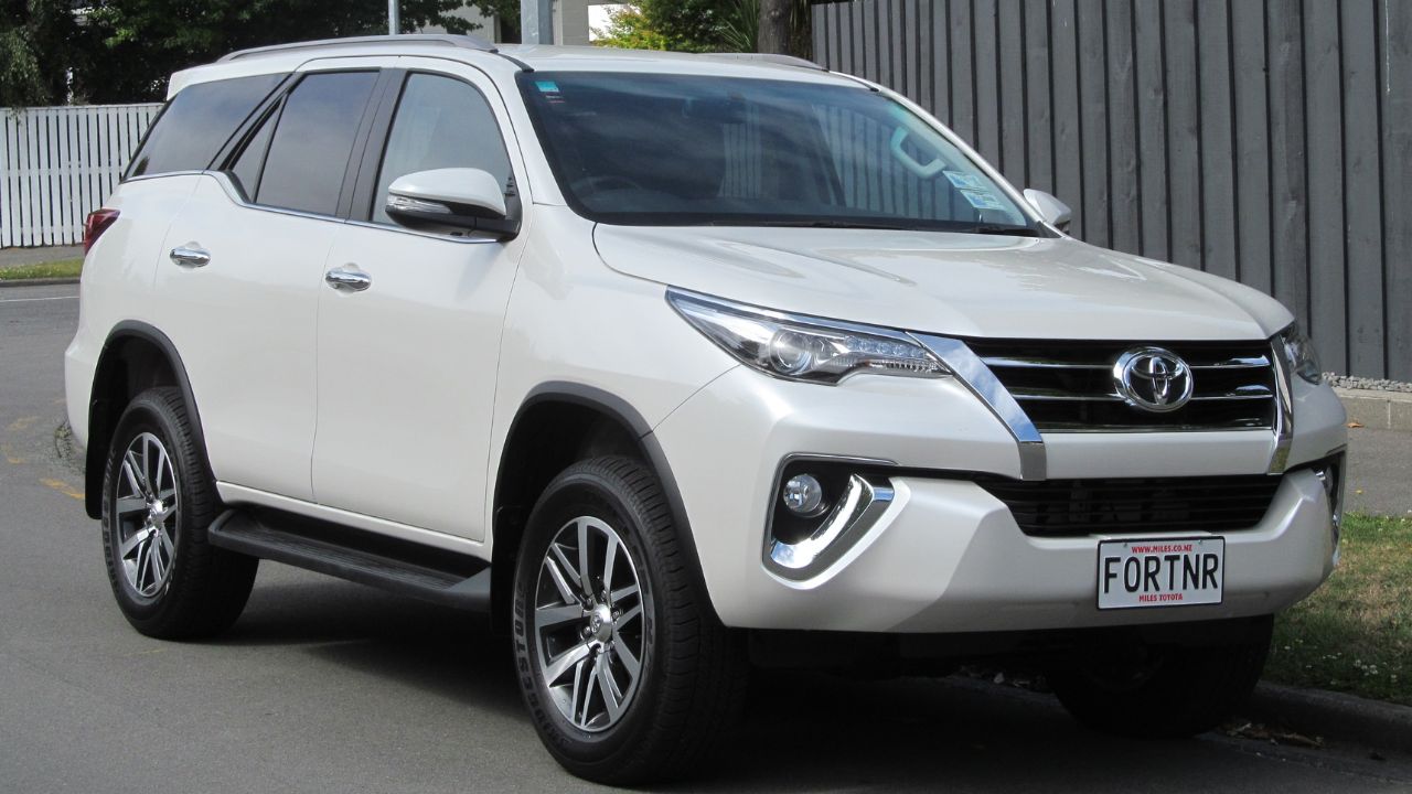 Toyota Fortuner SUV on road in side in white color